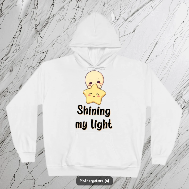 Funny hoodie with a curious moon character peeking above a giggling star. Warm and stylish.
