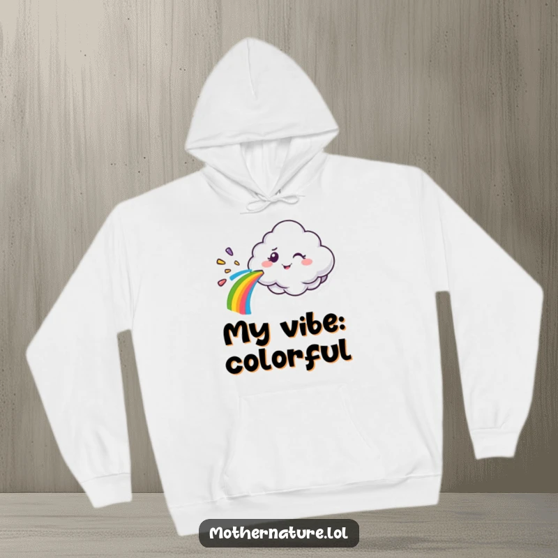 Funny cloud character hoodie, spraying a vibrant rainbow with a mischievous wink, perfect for cozy comfort and humor.