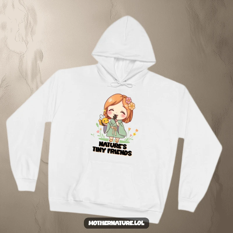 Funny hoodie of Mother Nature smiling, holding a small, buzzing bee, representing a deep and joyful connection to the natural world.